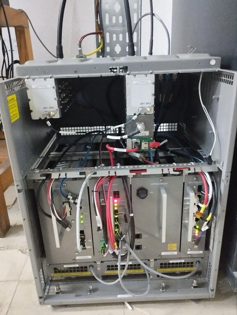 Open network-radio MTS equipment rack showing installed modules and structured cabling
